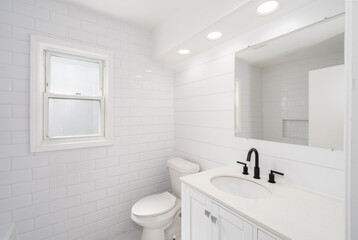 bathroom has been remodeled with a new vanity and fixtures