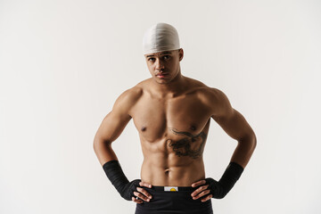 Obraz na płótnie Canvas Young shirtless sportsman with tattoo posing on camera