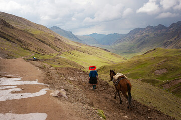 Peruvian woman with a horse at Vinicunca Rainbow mountain, Cusco province, Peru