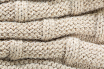 Fototapeta na wymiar textured brown macro sweater,Seamless texture of handmade knitting of natural yarn. Sheep common wool. Knitted background. Closeup