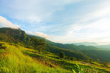 Fototapeta premium Mountain and sky view in the morning,The first or last rays of the sun on a mountain pass. Morning and evening in nature. Colorful sunset and sunrise over the mountain hills