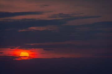 Sunset of a big, scarlet sun.