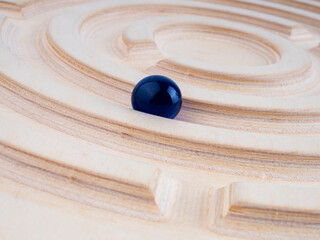 Wooden labyrinth balance board on white background. Close-up. Montessori toy