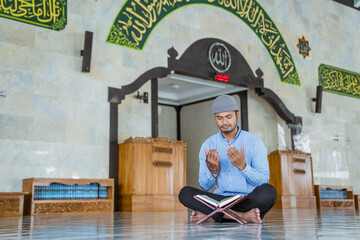 portrait of asian Man muslim doing prayer in the mosque and reading quran