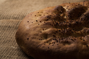 Close up shot of a Ramadan pita bread on a jute background