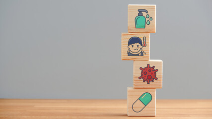 Healthcare and medicine concept, wooden cubes with medical icons and symbols on gray background, copyspace.