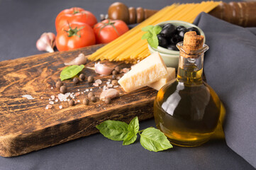 Italian cuisine cooking spaghetti with tomato sauce and olives.