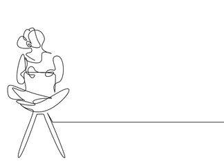 woman sitting comfortably in chair using laptop and looking up thinking