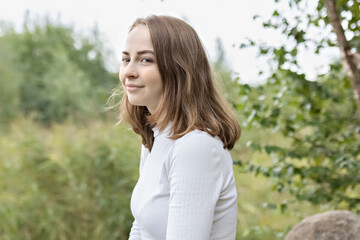 Fototapeta premium Portrait of a young teenager girl in the park. Spring.