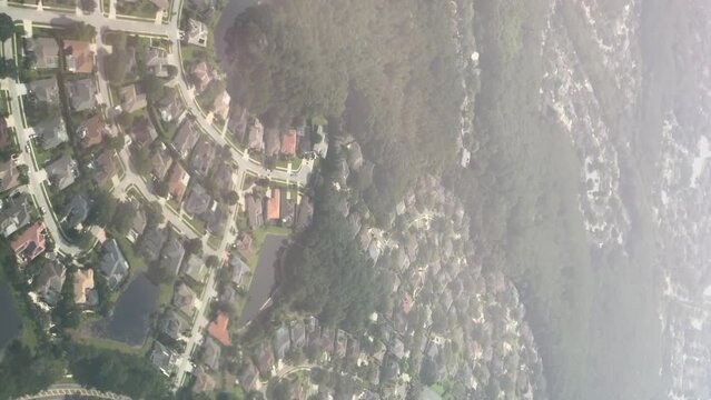 Vertical view from the window of a plane over residential homes in Tampa Florida