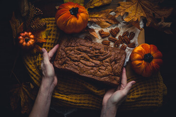 Overhead view of woman holding fresh baked pumpkin bread
