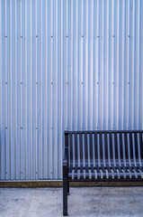 Black bench against a silver background.