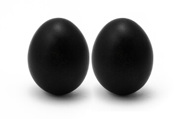 Two black egg isolated on a white background. Pair of painted eggs for Easter holiday. Black Easter. The concept of uniqueness and individuality. Standing couple eggs