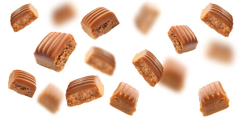 Falling toffee caramel candies isolated on white background. Texture