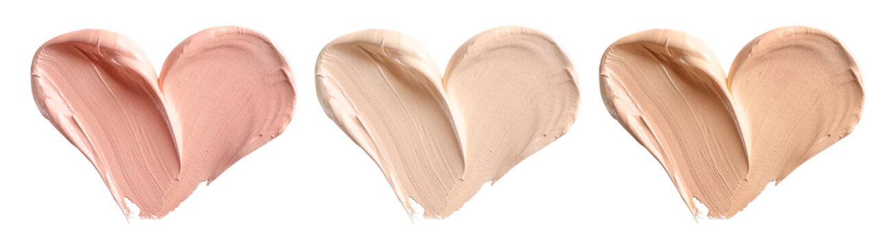 Makeup foundation, cosmetic cream smear in shape of heart isolated on white background.