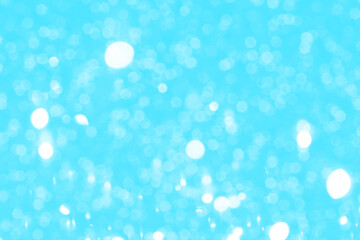 Bright blue sparkling glitter bokeh background, abstract defocused lights texture