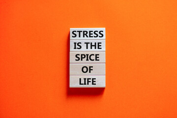 Stress spice of life symbol. Concept words Stress is the spice of life on wooden blocks. Beautiful orange table orange background. Business motivational stress spice of life concept. Copy space.