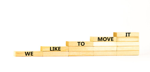 We like to move it symbol. Concept words We like to move it on wooden blocks. Beautiful white table white background. Business motivational We like to move it concept. Copy space.