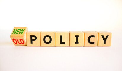 New or old policy symbol. Turned wooden cubes changed concept words Old policy to New policy....