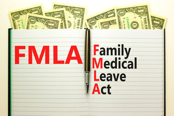 FMLA family medical leave act symbol. Concept words FMLA family medical leave act on book on...