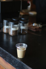 Closeup of Iced Caramel Macchiato at the coffee shop, Caramel Macchiato is a classic macchiato beverage. It consists of vanilla syrup, espresso, steamed milk, foam, and caramel drizzle
