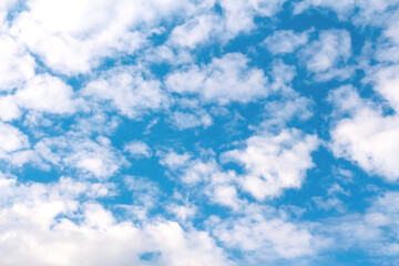 Naklejka na ściany i meble Defocus blue sky background with tiny white clouds. Panorama blue sky background with clouds. Abstract blurred piece background. Spring sky. Out of focus