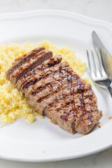 beef steak served with couscous