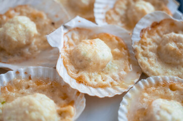 Plate with delicacy roasted scallops with cheese
