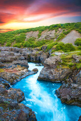 Beautiful mystical landscape with river in canyon Kolugljufur  between the rocks in Iceland at red...