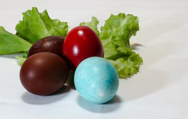 Easter eggs. Spring still life.Multicolored Easter eggs and leaves on a light background