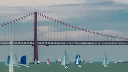 Sailfishes on the Tagus river with 25th of April Suspension Bridge on background timelapse
