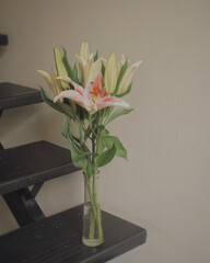 flowers in vase on staircase 
