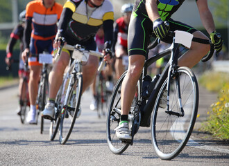 Naklejka na ściany i meble many cyclists ride on the racing bikes during the road cycling race