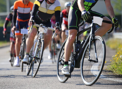 many cyclists ride on the racing bikes during the road cycling race