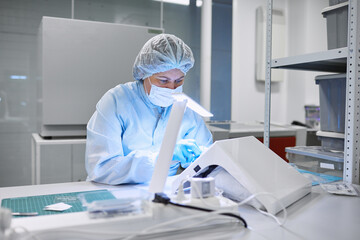 A female scientist processes the material in a clean room