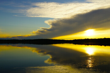 Fototapeta na wymiar Colorful reflection of sun in the seawater a minute before total sundown