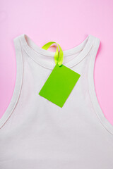 price tag hang over white  t-shirt on  pink background - Image