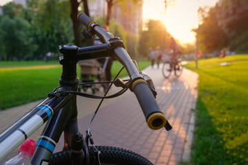 Fototapeta na wymiar Bicycle close-up in the city park at sunset. Sports lifestyle