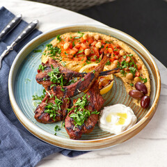 Raw rack of lamb fried with aromatic olive oil, herbs and spices