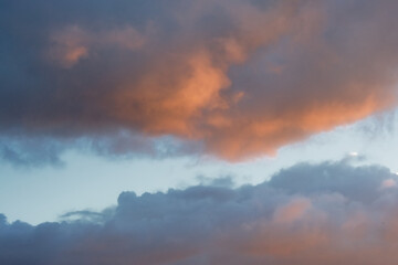 Colorful cloudy evenig sky in blue, orange and grey
