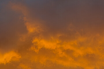 Colorful cloudy evenig sky in blue, orange and grey