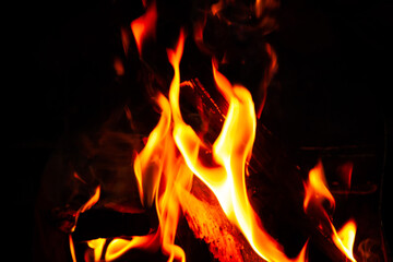 Mountain summer. Bonfire in night. Black background