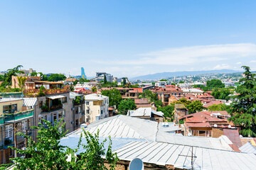 Scenic aerial beautiful view panorama of old historic city Tbilisi center, architecture buildings roofs, Georgia in summer sunny day, nature bright landscape