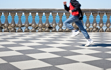 Happy child runs on the famous Mascagni terrace (Italy - Tuscany - Livorno city) - Unrecognizable...
