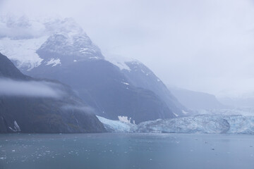 Glacier at Glacier Bay National Park with mountains in background, Alaska