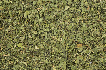 Dried and chopped celery leaves as background, top view.