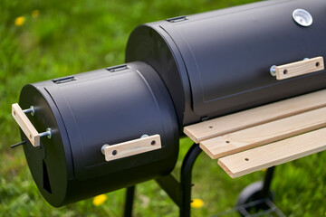 New smoker barbecue grill. Equipment for cooking and smoking. Closeup.