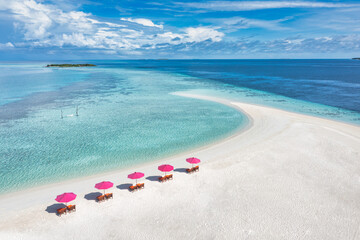 Aerial view, amazing beach with umbrellas and lounge chairs beds close to turquoise sea. Beautiful...