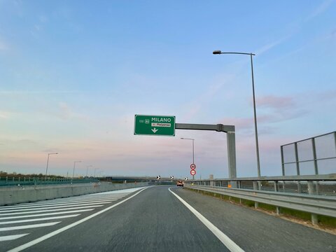 Milano, Italy, 12.04.2022. Italian highway with road sign indicating Milano Malpensa airport.