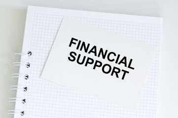 A white card with the FINANCIAL SUPPORT. Financial concept
